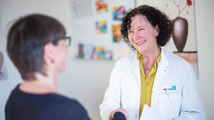 Ärztin schüttel Patientin beim Abschlussgepräch die Hand