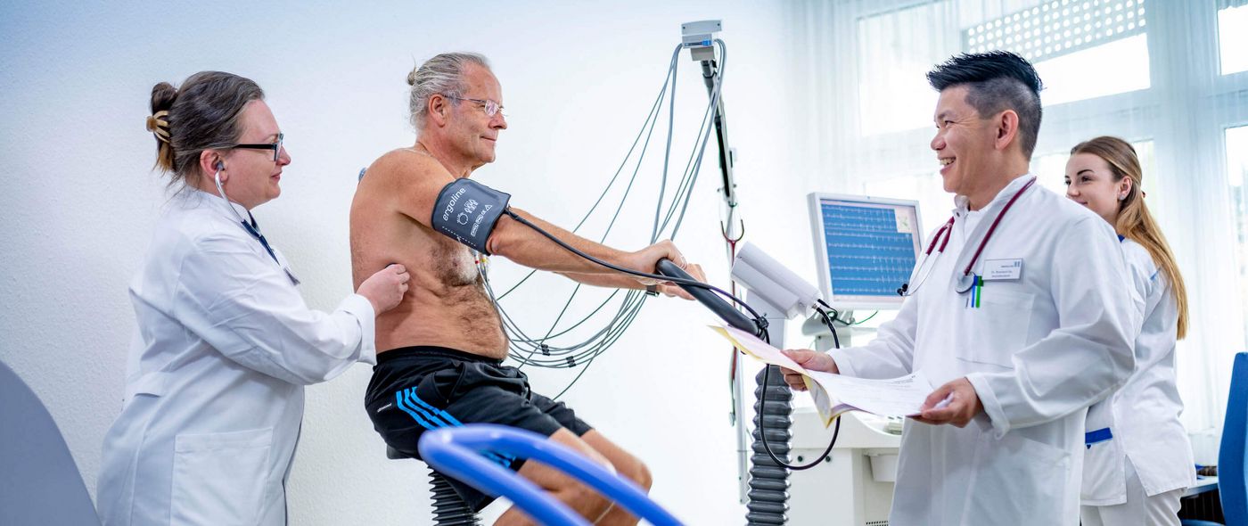 Ärzte untersuchen einen Patienten beim Belastungs-EKG
