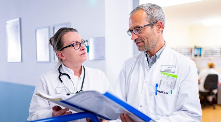 Ärztin und Arzt analysieren gemeinsam eine Patientenakte